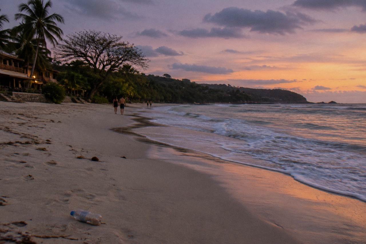 Wide sandy beach at dusk with gentle surf along the Pacific coast of Guanacaste