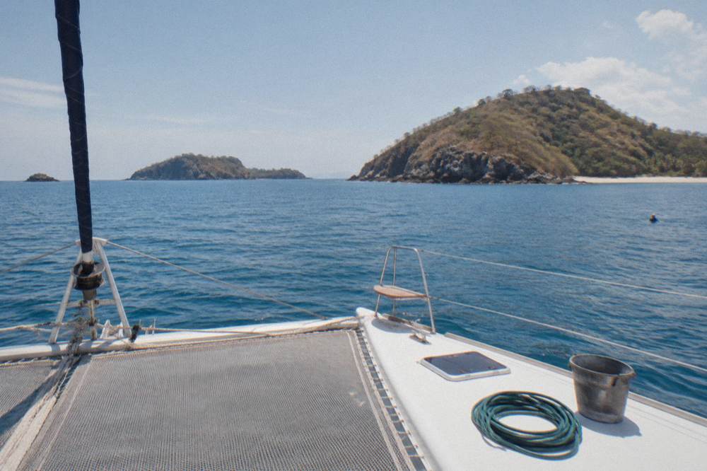 Calm Pacific horizon at midday seen from a catamaran deck