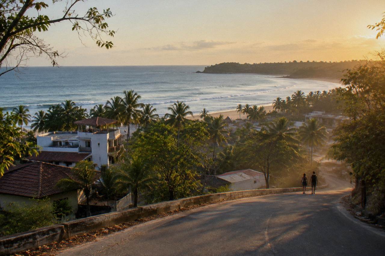 Coastal road curving toward Tamarindo beach with the Pacific horizon in the distance