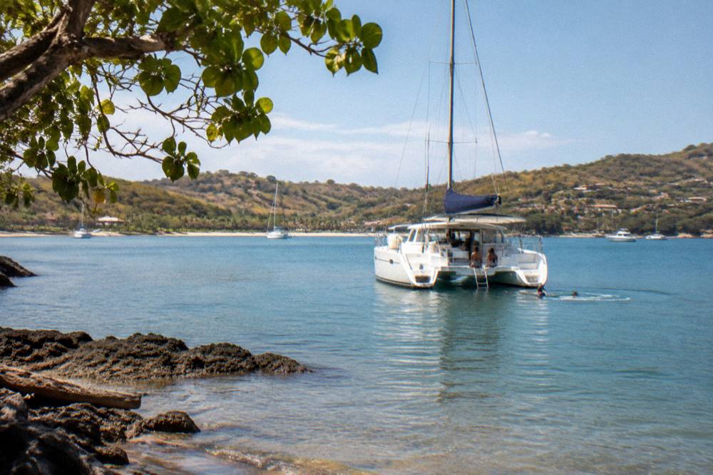 Catamaran anchored in a quiet bay with calm turquoise water