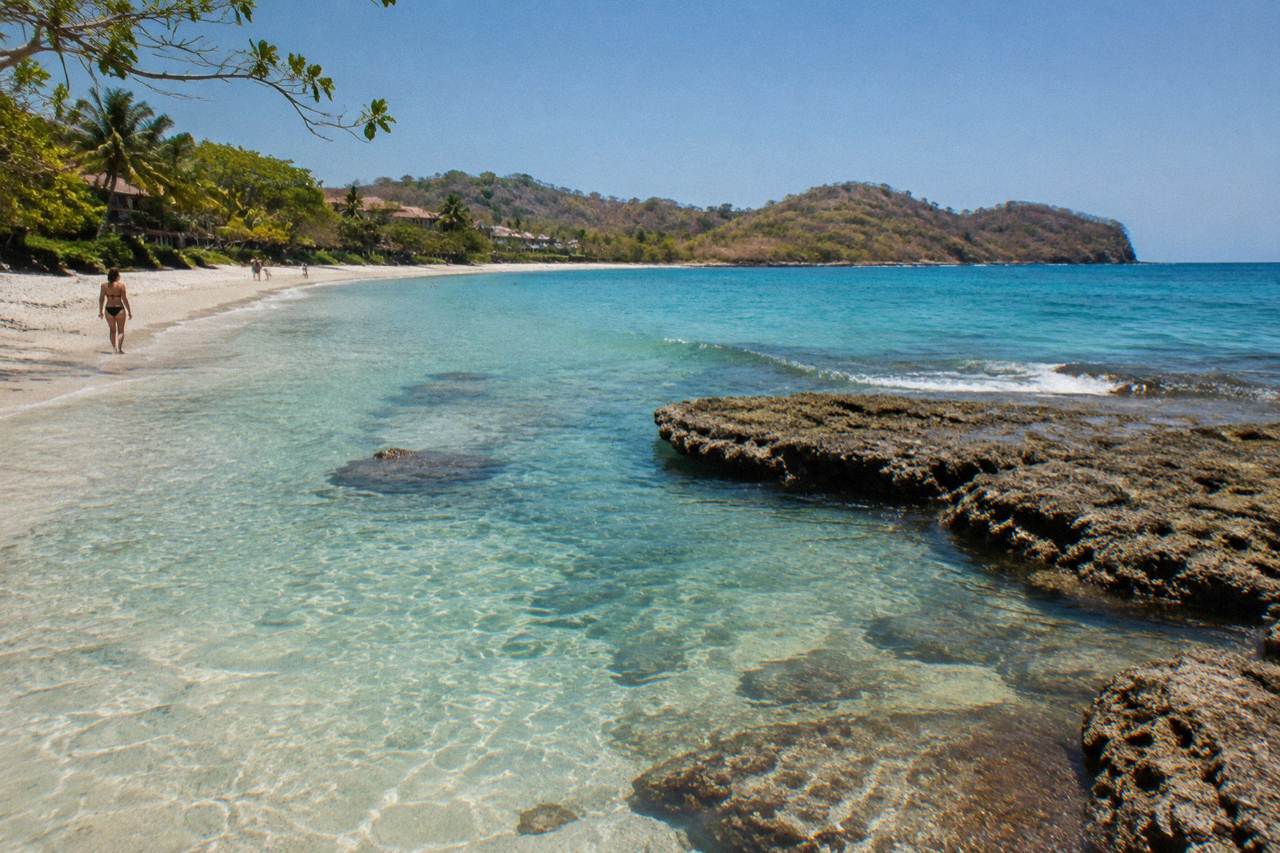 Calm turquoise water over a rocky reef along the Guanacaste coast