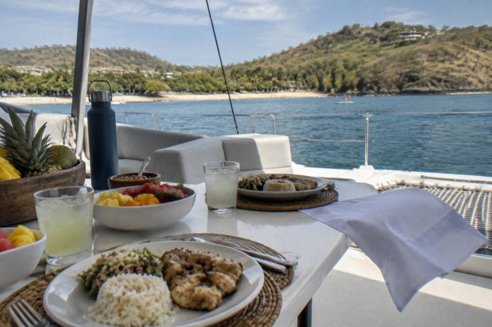 Catamaran lunch spread and drinks set on deck table before service